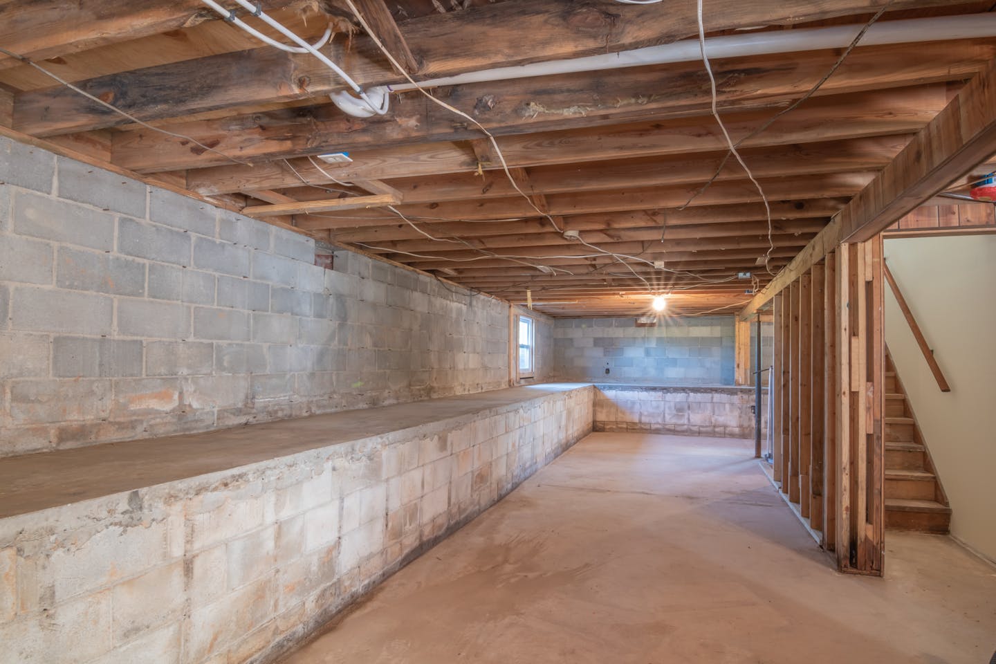 Basement interior showing water damage along the foundation wall in Bloomfield NJ